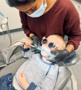 A child's first dental visit in the exam room