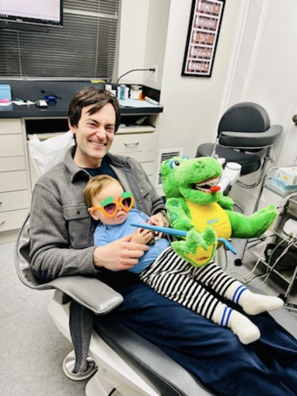 patient and his dad in dental exam chair