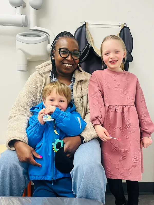 Lady and 2 little children in dental office